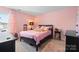 Pink bedroom with a bed, a nightstand, and a window at 124 Sequoia Forest Dr, Mooresville, NC 28117