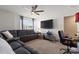 Comfortable living room featuring a sectional couch, TV, and a work desk at 124 Sequoia Forest Dr, Mooresville, NC 28117