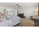 Bright and spacious main bedroom featuring a ceiling fan and large mirror at 124 Sequoia Forest Dr, Mooresville, NC 28117