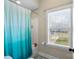 Cozy bathroom features a shower with colorful curtain and a street view window at 130 Monteray Oaks Cir, Fort Mill, SC 29715