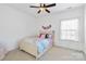 Bright bedroom with a ceiling fan, window, and a colorful bedspread at 130 Monteray Oaks Cir, Fort Mill, SC 29715