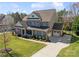 A beautifully designed home featuring a manicured lawn, complemented by a driveway and a two-car garage at 130 Monteray Oaks Cir, Fort Mill, SC 29715