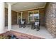 Inviting front porch with rocking chairs, columns, and a charming entrance at 130 Monteray Oaks Cir, Fort Mill, SC 29715