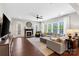 Cozy living room with a fireplace, large windows, hardwood floors and comfortable seating at 130 Monteray Oaks Cir, Fort Mill, SC 29715