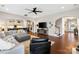 Open-concept living room with hardwood floors, a large sectional sofa, and arched doorways to other rooms at 130 Monteray Oaks Cir, Fort Mill, SC 29715