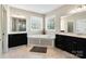 Bright main bathroom featuring dual vanities, garden tub, and separate walk-in shower at 130 Monteray Oaks Cir, Fort Mill, SC 29715