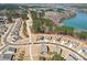 An aerial view shows the home's position within a community and its proximity to a lake at 1300 Dali Blvd, Mount Holly, NC 28120