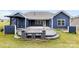 Aerial view showing outdoor patio, stone bench, outdoor kitchen and green grass at 1300 Dali Blvd, Mount Holly, NC 28120