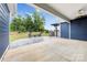 Backyard area shows patio, stone bench, planters, and a well-maintained lawn at 1300 Dali Blvd, Mount Holly, NC 28120