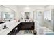 Modern bathroom with double sinks, dark cabinets, a large mirror, and glass shower at 1300 Dali Blvd, Mount Holly, NC 28120