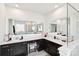 Bathroom featuring double sink vanity, framed mirrors, and glass-enclosed shower at 1300 Dali Blvd, Mount Holly, NC 28120