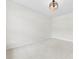 Bright, carpeted bedroom with a modern light fixture and neutral walls at 1300 Dali Blvd, Mount Holly, NC 28120