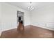 An elegant dining room with wainscotting and hardwood floors at 1300 Dali Blvd, Mount Holly, NC 28120