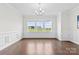 Elegant dining room with wainscoting, hardwood floors and a large window at 1300 Dali Blvd, Mount Holly, NC 28120