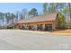 Exterior of the building features a row of outdoor rocking chairs and glass door garages at 1300 Dali Blvd, Mount Holly, NC 28120