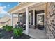 Inviting front porch showcases rocking chairs, a decorative wreath, and a well-maintained garden, enhancing the curb appeal at 1300 Dali Blvd, Mount Holly, NC 28120