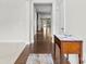 Bright hallway with hardwood floors leading to an open living space and backyard view at 1300 Dali Blvd, Mount Holly, NC 28120