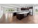 Spacious kitchen with dark wood cabinets, stainless appliances, and a large island at 1300 Dali Blvd, Mount Holly, NC 28120