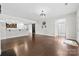 Bright and open living room with hardwood floors, white walls and access to kitchen at 1300 Dali Blvd, Mount Holly, NC 28120