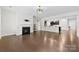 Bright living room featuring a fireplace and open access to the kitchen with sleek hardwood floors at 1300 Dali Blvd, Mount Holly, NC 28120