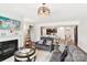 Open-concept living room showcasing a fireplace and seamless transition into the kitchen area at 1300 Dali Blvd, Mount Holly, NC 28120