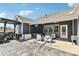 Relaxing outdoor patio featuring an outdoor kitchen, TV, dining area, and cozy seating arrangement at 1300 Dali Blvd, Mount Holly, NC 28120