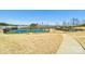 Community tennis courts featuring multiple courts, walking trails, and a wooded area in the background at 1300 Dali Blvd, Mount Holly, NC 28120