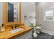 Chic bathroom vanity with wood counter, modern fixtures, and natural light at 1418 Seigle Ave, Charlotte, NC 28205