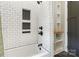 Tile bathroom with tiled shower niche, modern shower fixtures, and tub at 1418 Seigle Ave, Charlotte, NC 28205