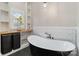 Modern bathroom with a freestanding tub, black slate tile and open shelving at 1418 Seigle Ave, Charlotte, NC 28205