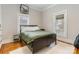 Bright bedroom with wood floors, large window, and neutral decor at 1418 Seigle Ave, Charlotte, NC 28205