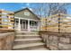 Landscaped front yard and charming home entrance with a decorative retaining wall and steps at 1418 Seigle Ave, Charlotte, NC 28205