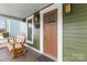 Inviting front porch featuring a stylish bench, lantern sconces, and convenient mailbox at 1418 Seigle Ave, Charlotte, NC 28205