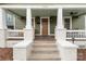 Inviting front porch with classic columns and a charming entrance to the home at 1418 Seigle Ave, Charlotte, NC 28205