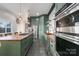 Spacious kitchen featuring stainless steel appliances, a large island, green cabinetry, and a butcher block countertop at 1418 Seigle Ave, Charlotte, NC 28205