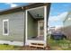 View of home's covered porch, outdoor fan, and yard at 1418 Seigle Ave, Charlotte, NC 28205