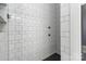 Stylish shower with black fixtures and contrasting white subway tile at 1418 Seigle Ave, Charlotte, NC 28205