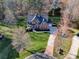 Aerial view of a beautiful brick home with mature trees and lush landscaping in a well-maintained neighborhood at 15100 Durmast Ct, Mint Hill, NC 28227