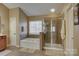 Bright bathroom featuring a soaking tub, glass shower, neutral tones and tile floors at 15100 Durmast Ct, Mint Hill, NC 28227