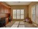 Bright bedroom featuring built-in cabinetry and a large window with plantation shutters for abundant natural light at 15100 Durmast Ct, Mint Hill, NC 28227