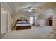 Spacious bedroom featuring tray ceilings, neutral colors, carpet, and natural light at 15100 Durmast Ct, Mint Hill, NC 28227