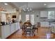 Charming dining area adjacent to kitchen, featuring a chandelier and views of the lush backyard at 15100 Durmast Ct, Mint Hill, NC 28227