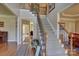 Inviting foyer with hardwood floors, staircase with wood and wrought iron railings, and ample natural light at 15100 Durmast Ct, Mint Hill, NC 28227