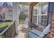 Charming covered front porch featuring comfortable seating and an American flag at 15100 Durmast Ct, Mint Hill, NC 28227