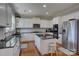 Modern kitchen with stainless steel appliances, granite countertops, and a central island for efficient meal preparation at 15100 Durmast Ct, Mint Hill, NC 28227