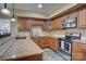 This charming kitchenette features wood cabinets, granite counters, a range, and a microwave at 15100 Durmast Ct, Mint Hill, NC 28227