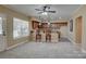 A stylish kitchenette features a bar area with stools, wooden cabinets, and a large window for natural light at 15100 Durmast Ct, Mint Hill, NC 28227