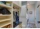 Convenient mudroom features a washer and dryer, built-in shelves, and storage for coats and shoes at 15100 Durmast Ct, Mint Hill, NC 28227