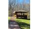 Community playground featuring a covered pavilion and a slide set against a wooded backdrop for outdoor fun at 15100 Durmast Ct, Mint Hill, NC 28227