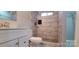 A modern bathroom featuring marble-patterned tiling in the stand-up shower, neutral colors, and vanity at 155 31St Sw St, Hickory, NC 28602